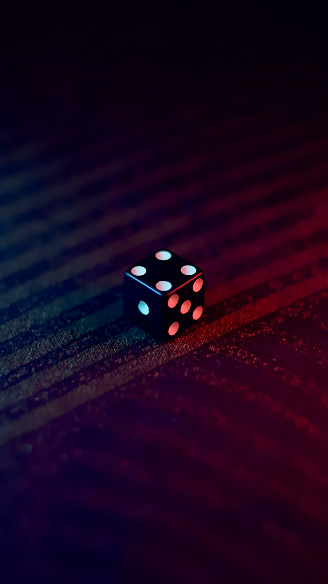 A black die set on abstract background.